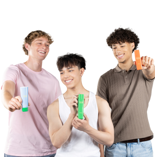 Three men holding skincare products and smiling.
