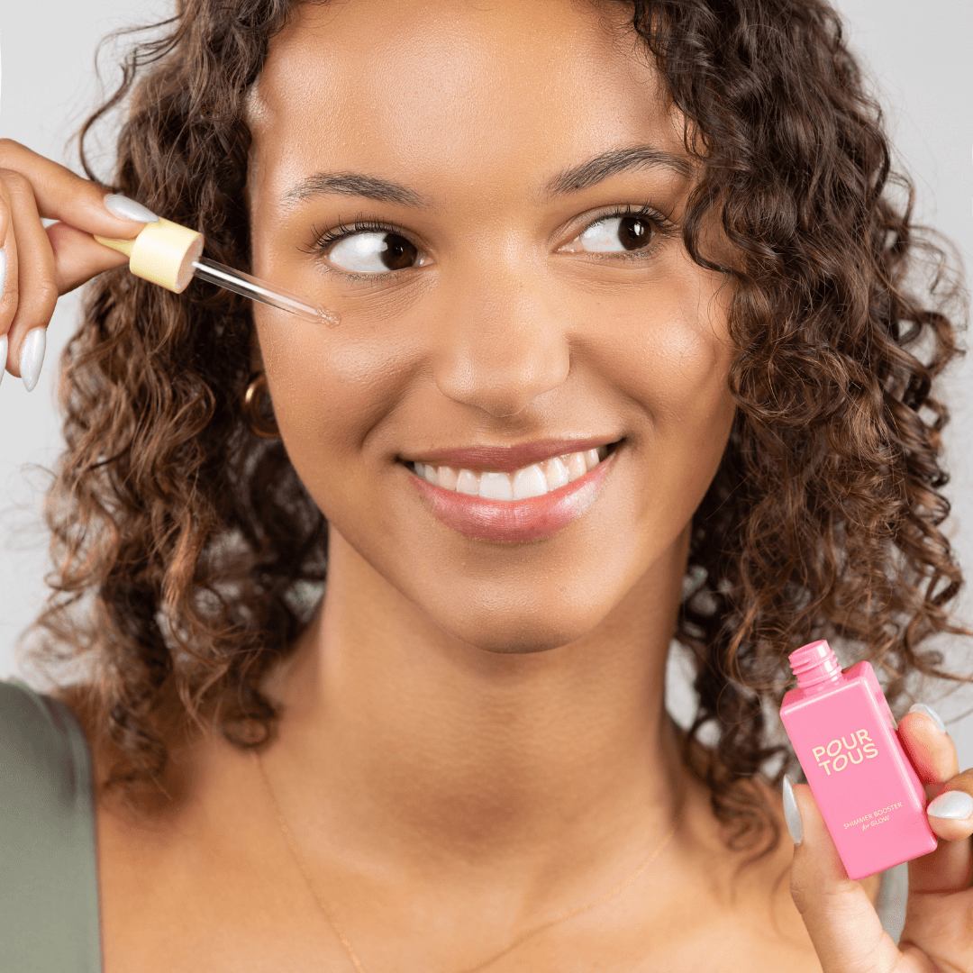 "woman applying facial serum skincare product"