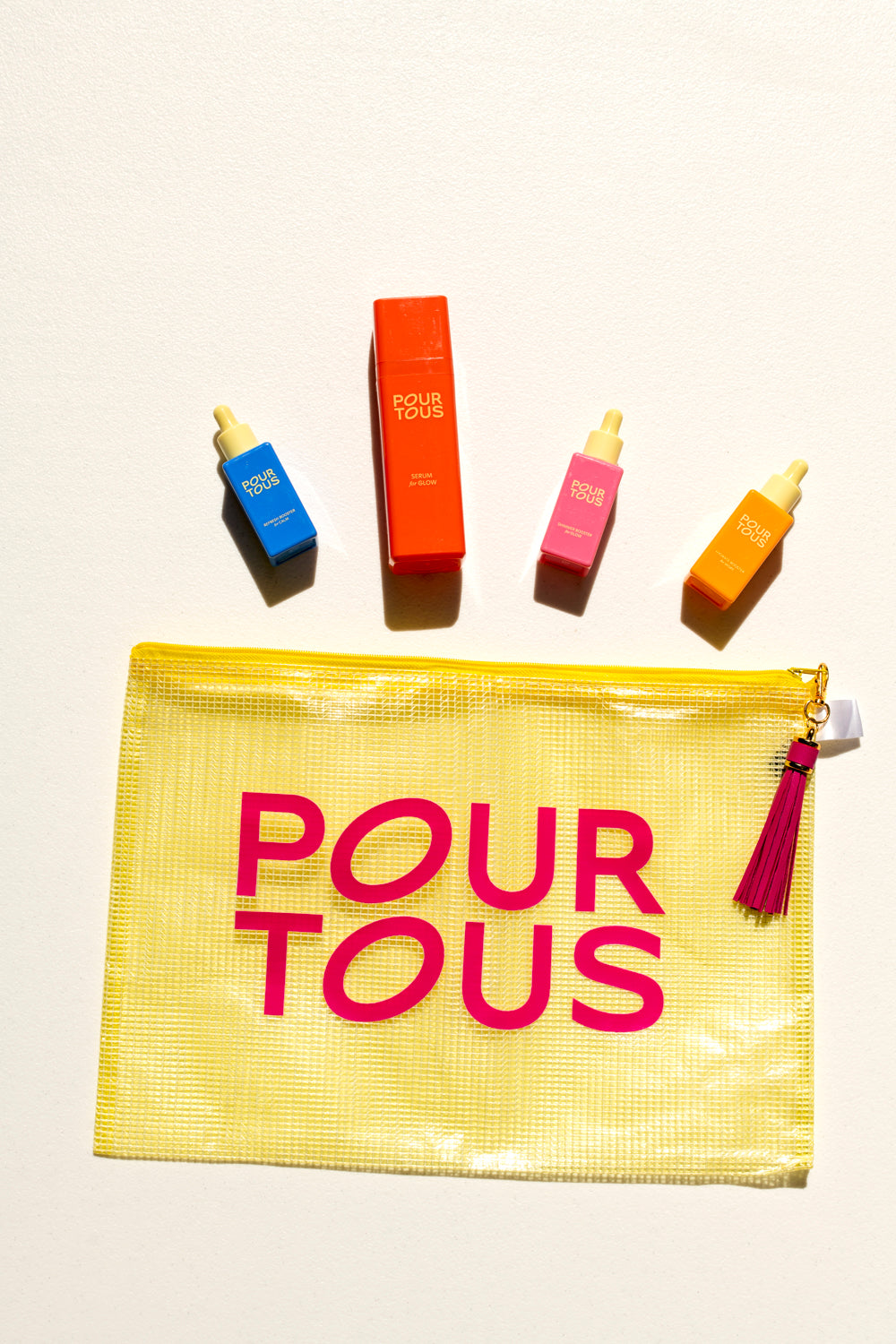 Pour Tous skincare products and cosmetic bag