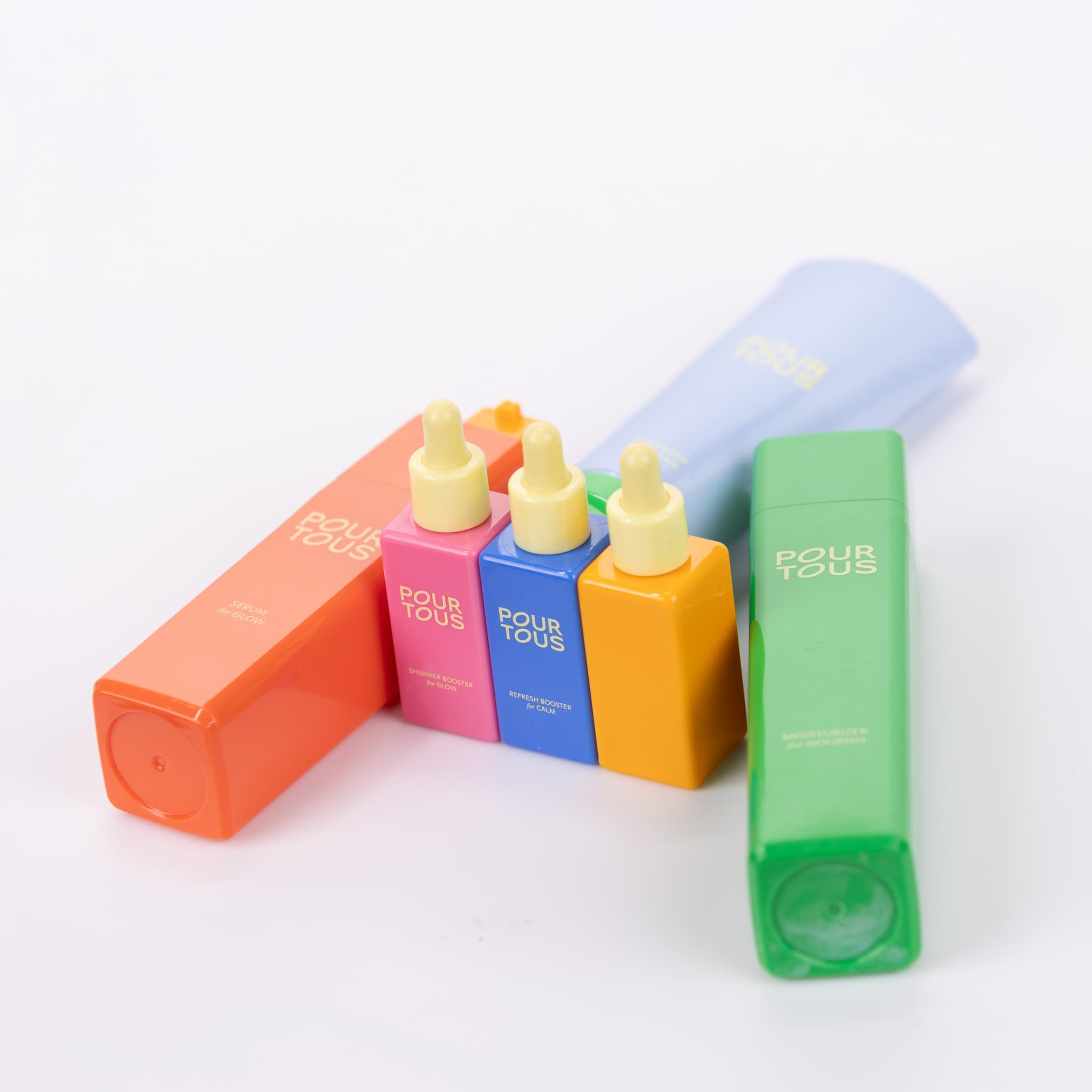 Colorful skincare bottles on white background