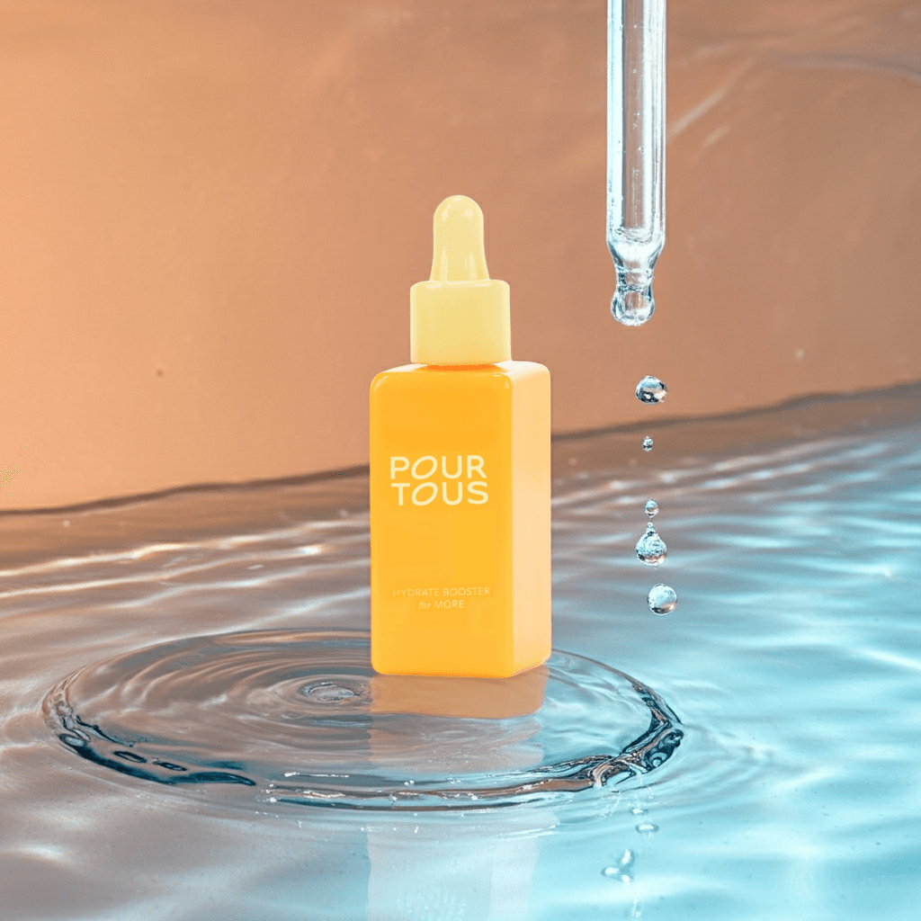 Pour Tous hydrate booster serum in water with dropper droplets.
